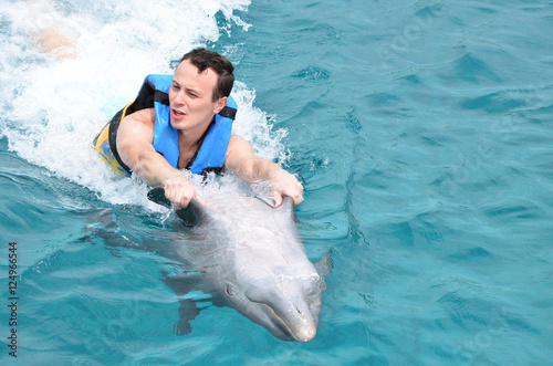 man holding dolphin fins photo