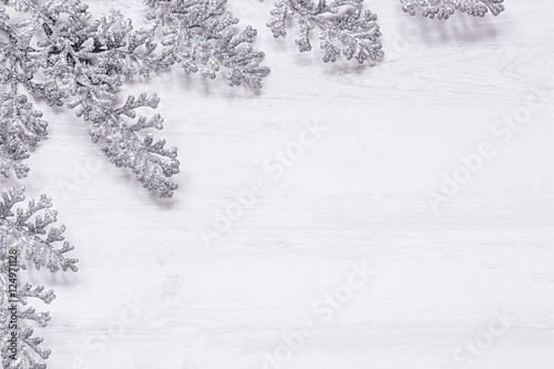 Christmas silver sprigs decoration on wooden white background. Xmas background.