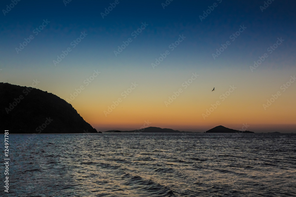 The sun rises over the Greek island of Patmos