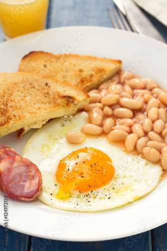 fried egg with beans, smoked sausage and toasts