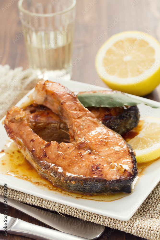 fried salmon with lemon on white dish fried salmon with lemon on white dish