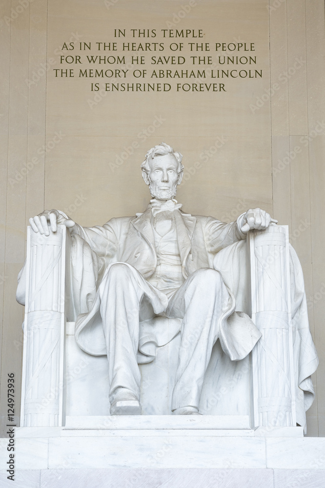 Statue of American president Abraham Lincoln seated in white marble under an epitaph at the Lincoln Memorial in Washington DC, USA 