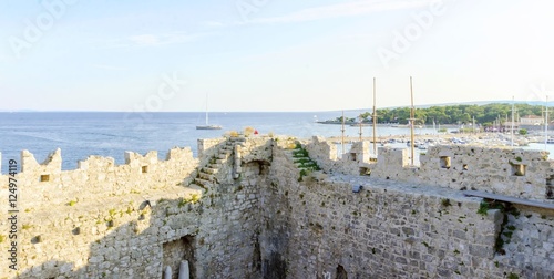The interior of the Frankopan Castle, at Kamplin square in Krk, Croatia - Frankopanski Kastel, part of the medieval city walls. View of the archer loop holes and sea port of the island