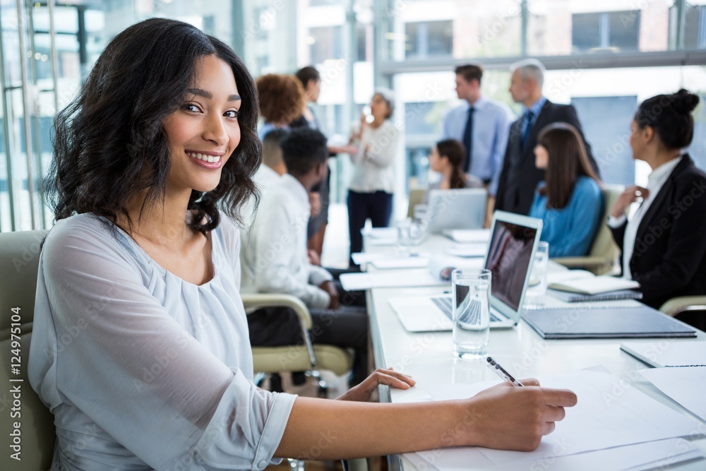Fototapeta premium Businesswoman writing notes in office