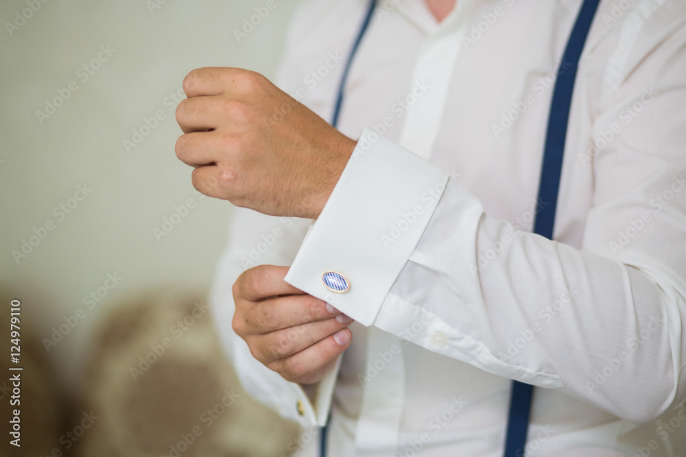 Mans hand wears white shirt and cufflink Mans hand wears white shirt and cufflink