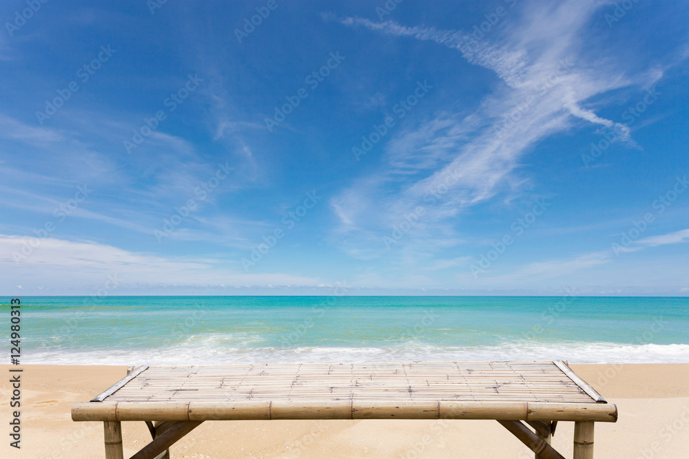Wooden bamboo sunbeds on old wood ,beautiful beach and sea Wooden bamboo sunbeds on old wood ,beautiful beach and sea