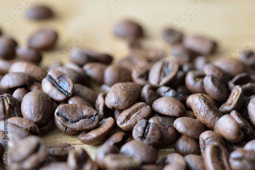 Roasted coffee beans on a wooden background