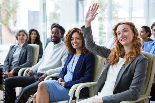 Businesswoman raising hand during meeting photo