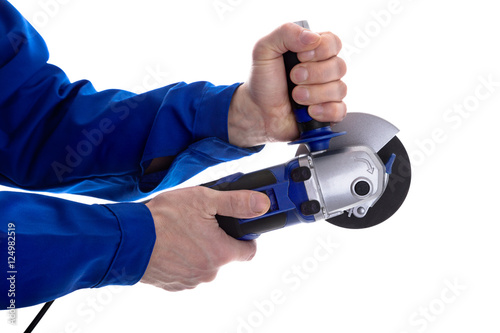 The worker holding angle grinder