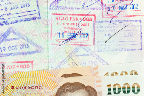 Fototapeta Naklejka Na Ścianę i Meble -  part of Thai banknote on opening passport with copy space