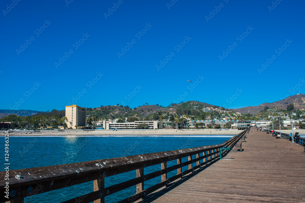 Wooden planks and vacation hotel as viewed from the Ventura Pier.