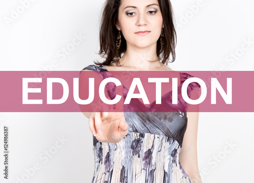 education written on virtual screen. technology, internet and networking concept. woman in a black business shirt presses button on virtual screens photo