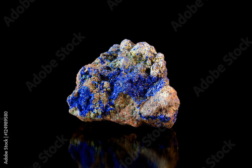 Multicolored rock with lazurite crystals on black background side view photo