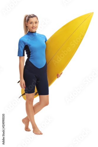 Female surfer posing with surfboard
