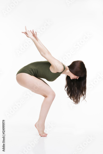 Young beautiful caucasian woman dancing in studio on white background