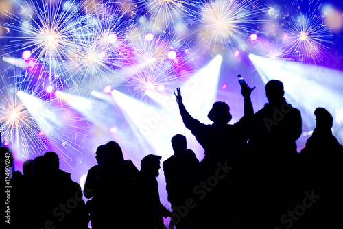 New Year concept. Celebrating crowd and fireworks