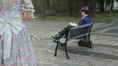 stranger woman sat down on a bench to the man