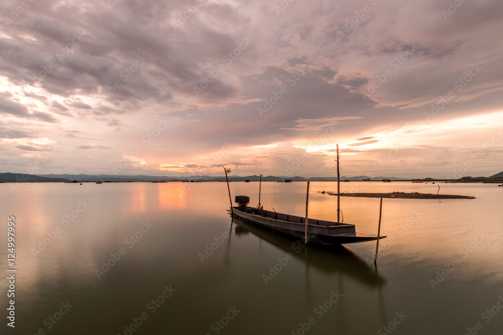Beautiful silhouette fishing boat in lake at Twilight sky. landscape
