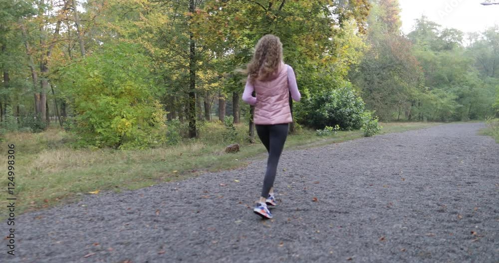 Woman run park young active fitness female runner exercising outdoor sport girl jogging morning autumn forest slow motion 60 fps Woman run park young active fitness female runner exercising outdoor sport girl jogging morning autumn forest slow motion 60 fps