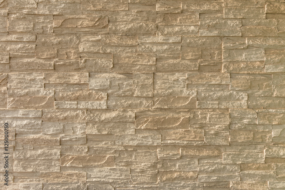 Obraz premium light brown stone brick exterior wall