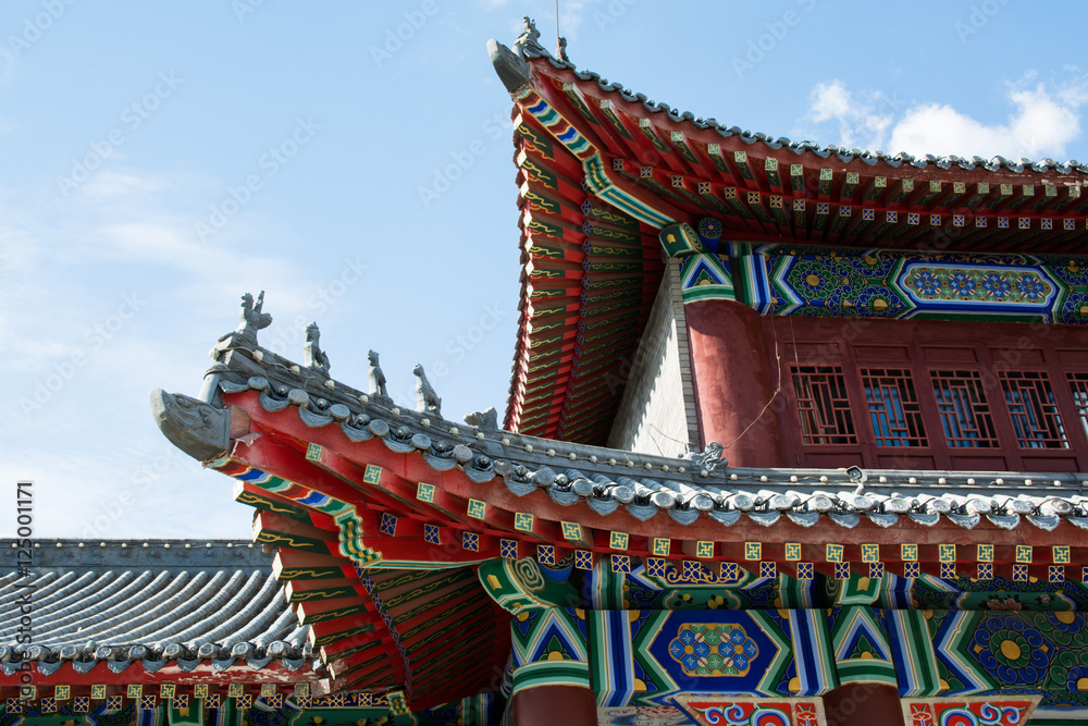 Part of eastern pagoda in sky background. Picturesque wooden elements of colorful roof. Part of eastern pagoda in sky background. Picturesque wooden elements of colorful roof.