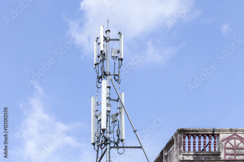 Cell phone tower on blue sky background.
