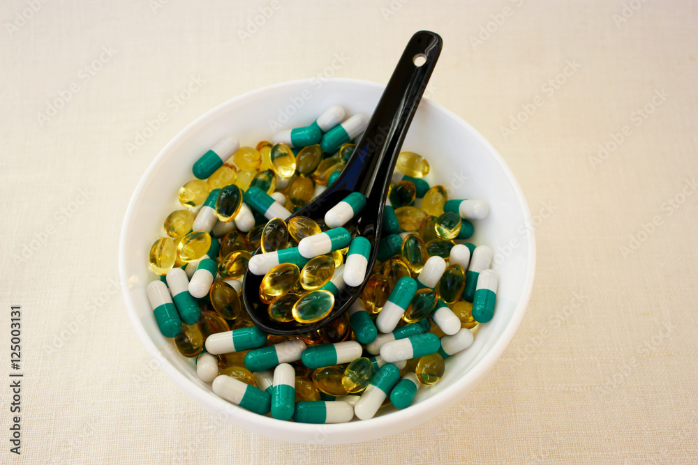 Pills in a bowl on a woven background Pills in a bowl on a woven background