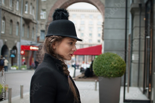 Young beautiful girl with red bag, wearing a black hat and leath