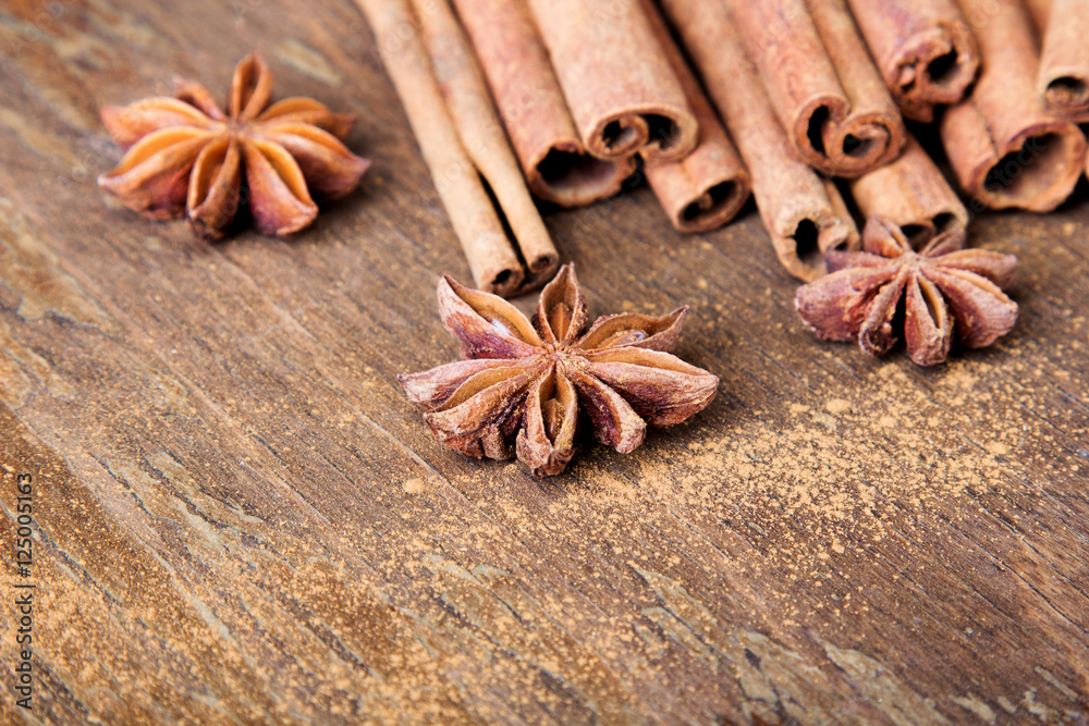cinnamon sticks and  star anise on wooden background