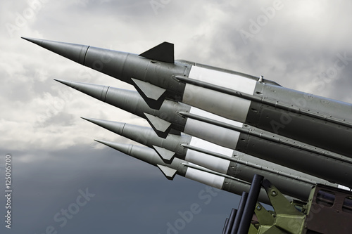 Nuclear Missiles With Warhead Aimed at Gloomy Sky. Balistic Rockets War Backgound.