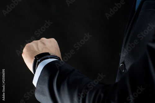 close up of businessman hand with smart watch
