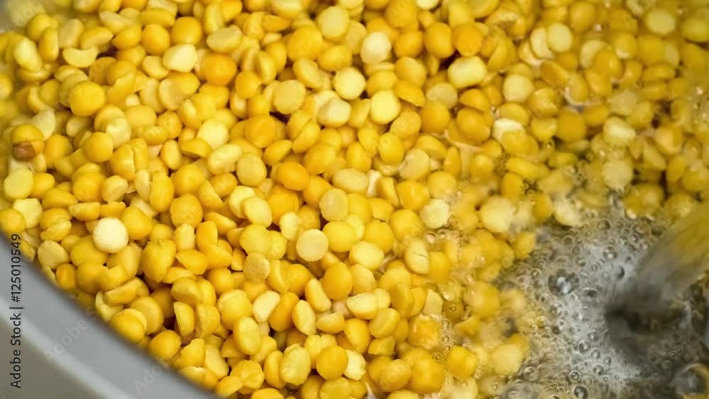 Water being added to cook pot containing yellow split pea lentils for cooking preparation, includes sound Water being added to cook pot containing yellow split pea lentils for cooking preparation, includes sound