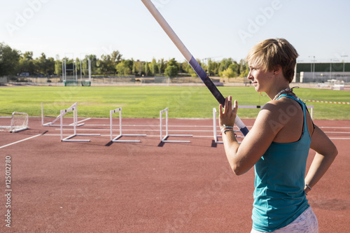 Female pole vaulter preparing