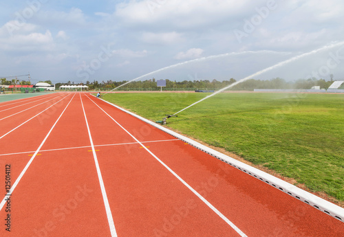Sprinkler watering to grass field in stadium © Soonthorn