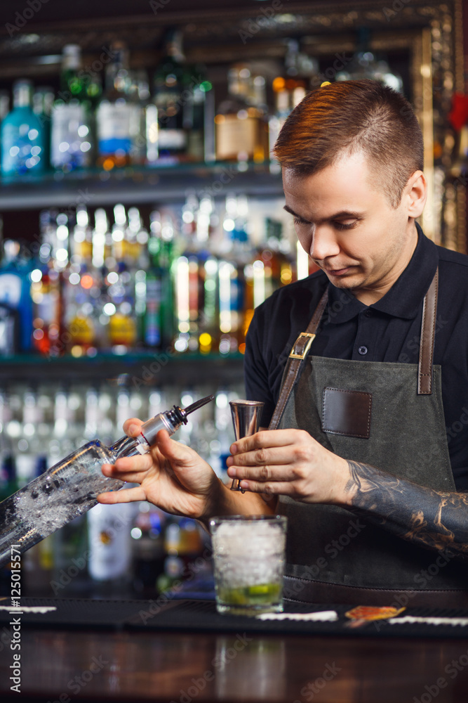 The bartender making cocktail