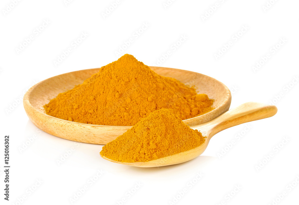 Turmeric Powder in wooden spoon isolated on white background Turmeric Powder in wooden spoon isolated on white background
