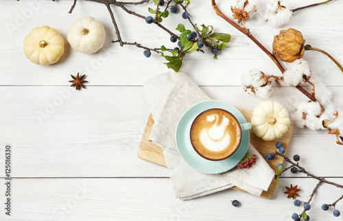 Pumpkin spice latte. Coffee top view on white wood background © Prostock-studio