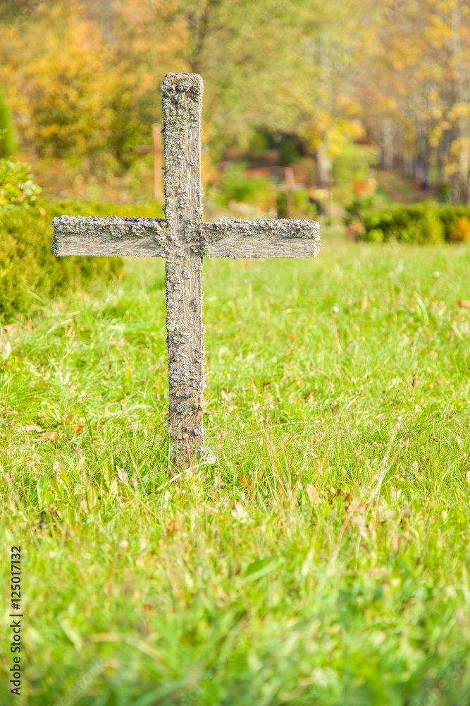 Abandoned, old, wooden cross in the cemetery in sunny autumn day. Peaceful place. Cemetery in Europe, Latvia. Abandoned, old, wooden cross in the cemetery in sunny autumn day. Peaceful place. Cemetery in Europe, Latvia.