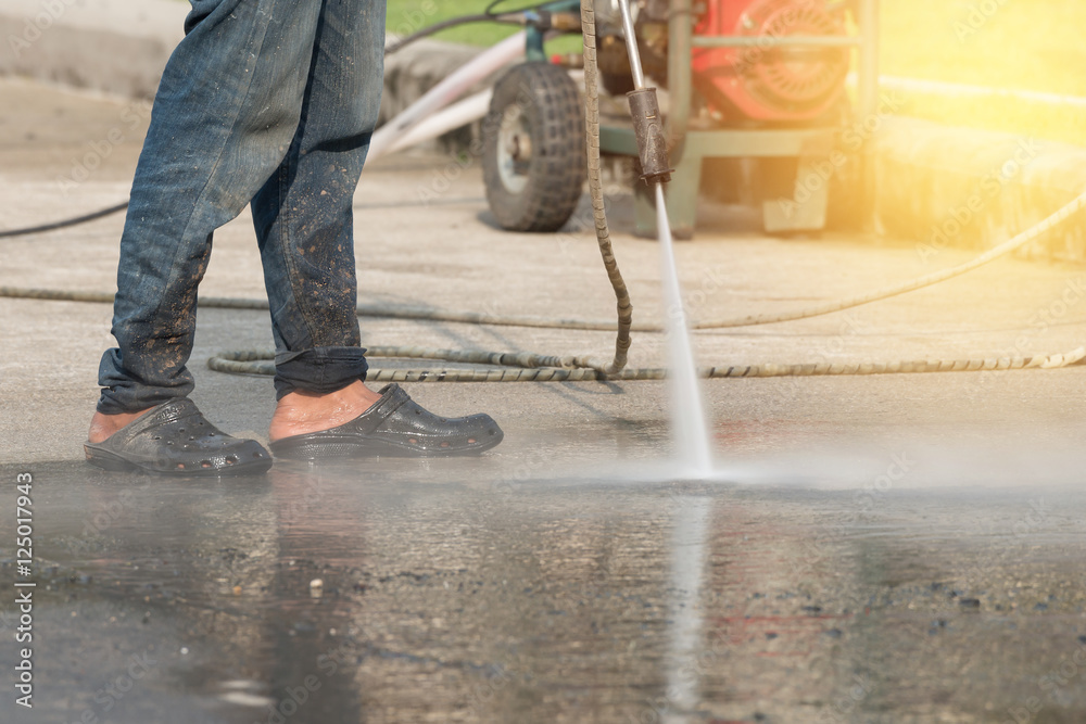 High pressure cleaning.Worker cleaning driveway with high pressure washer High pressure cleaning.Worker cleaning driveway with high pressure washer