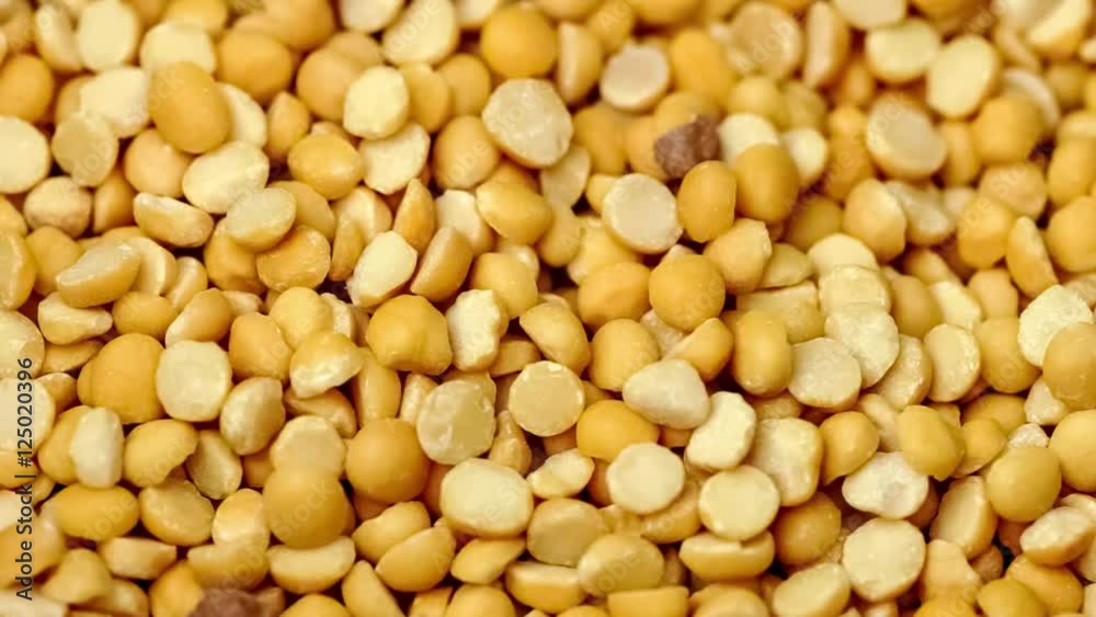 Closeup of metal cooking pot filling up with raw dehydrated yellow split pea lentils, includes sound Closeup of metal cooking pot filling up with raw dehydrated yellow split pea lentils, includes sound
