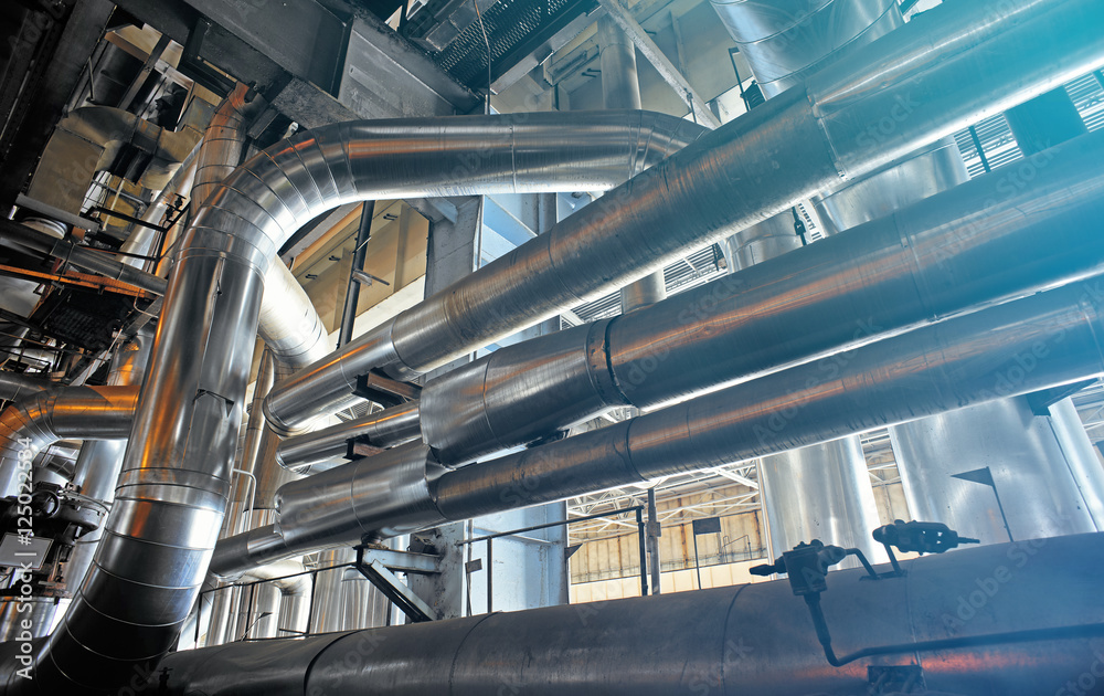 Equipment, cables and piping as found inside of a modern industr