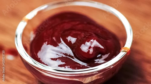 Macro of BBQ dipping sauce condiment filling up glass bowl