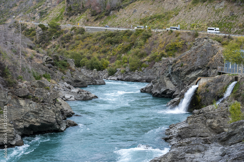 The Roaring Meg (Te Wai a Korokio) the turbulent stream that both drives this hydro electric power station and merges with the Kawarau River, Central Otago, south island of New Zealand The Roaring Meg (Te Wai a Korokio) the turbulent stream that both drives this hydro electric power station and merges with the Kawarau River, Central Otago, south island of New Zealand