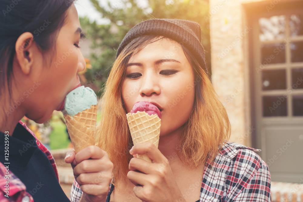 Close up shot of ice cream in hand of a woman standing with her Close up shot of ice cream in hand of a woman standing with her