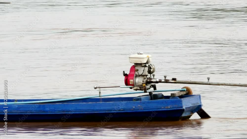 A trawler drive small motor ship and Trawl in the river at sunset time. A trawler drive small motor ship and Trawl in the river at sunset time.