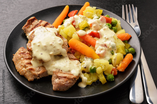 Grilled pork tenderloin and boiled vegetables with cream mustard sauce.