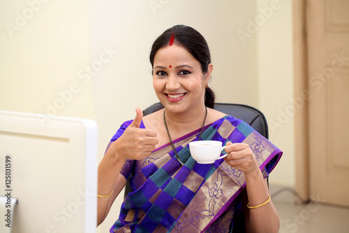 Photography Successful traditional Indian woman making thumbs up gesture