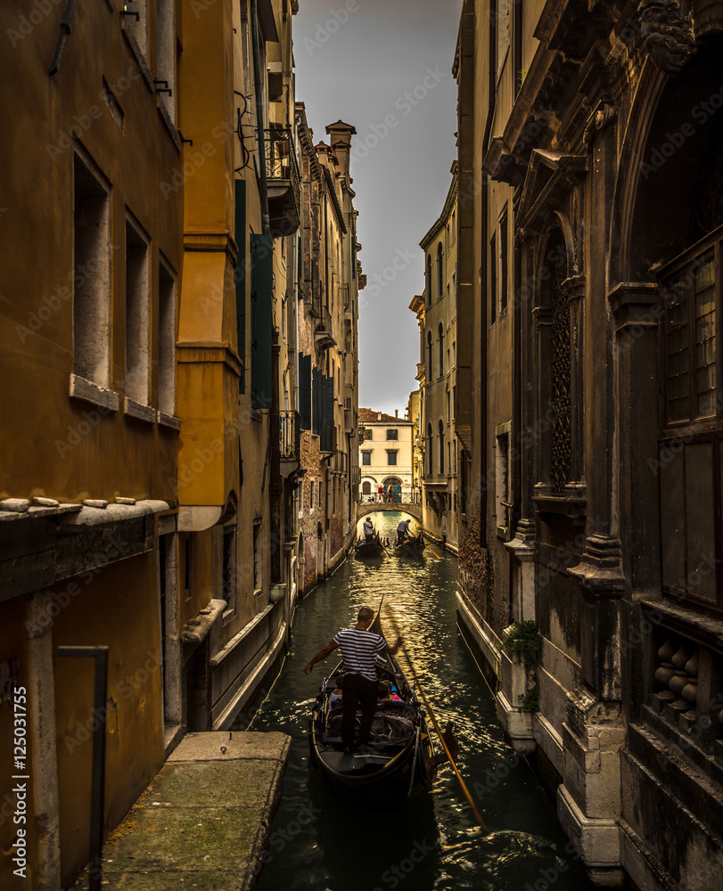 Italy beauty, gondolas in one of canal streets in Venezia , Venice
