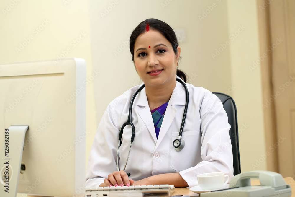 Happy traditional female doctor in hospital interior Happy traditional female doctor in hospital interior