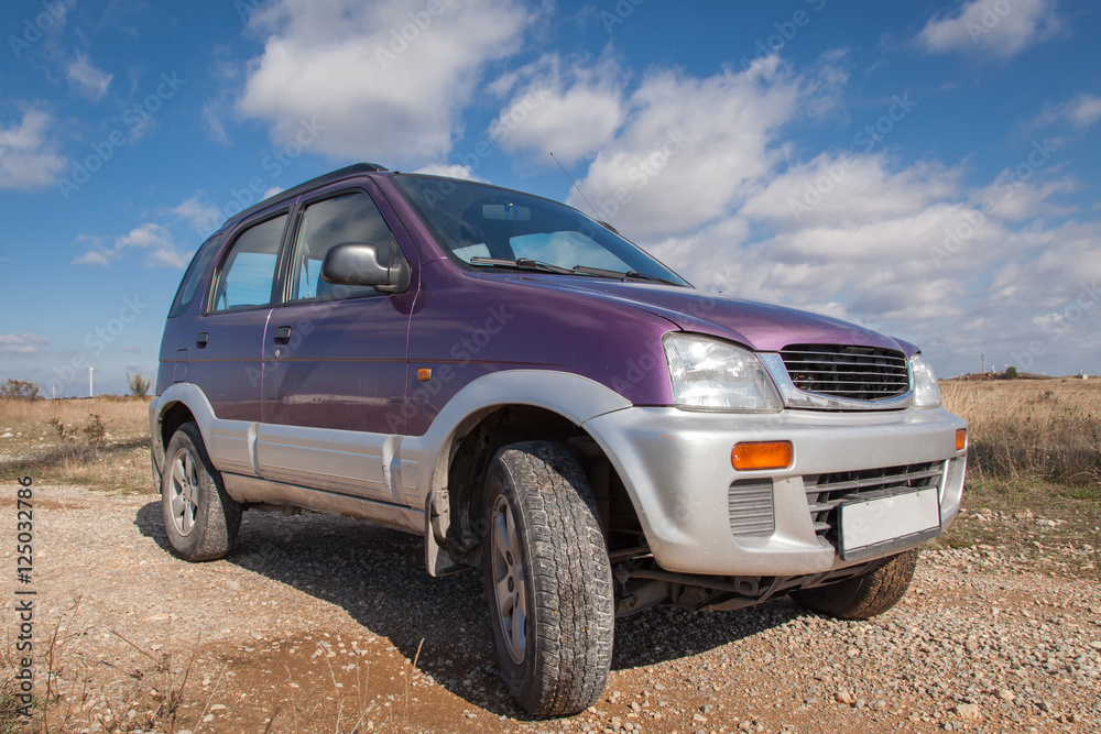 Off road car against bright cloudy sky. Crossover ,SUV car Off road car against bright cloudy sky. Crossover ,SUV car